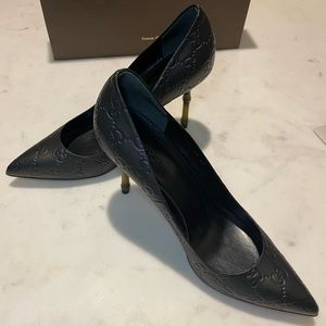 Black logo-embossed Gucci pumps with bamboo heel